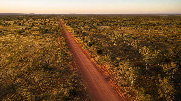 Aerial view of a remote road through the Beetaloo Basin bushland in the Northern Territory.